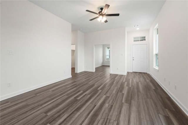 unfurnished living room with dark hardwood / wood-style flooring and ceiling fan