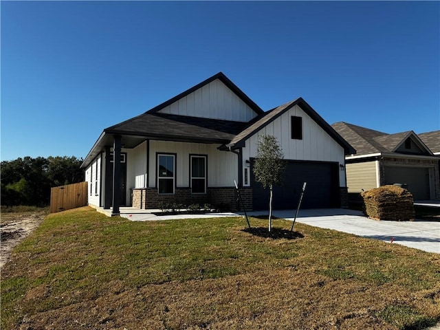 view of front of home with a front yard and a garage