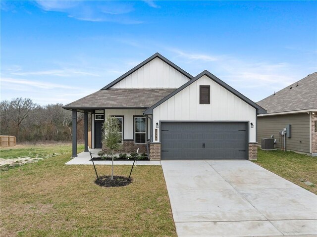 view of front of home with a front yard and a garage