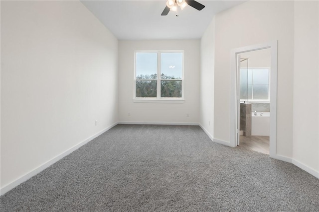 unfurnished bedroom with ceiling fan, ensuite bath, and carpet