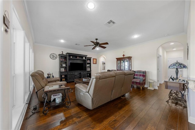 living room with ceiling fan, crown molding, and dark wood-type flooring