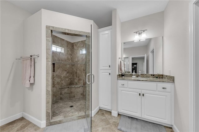 bathroom with tile patterned flooring, vanity, and a shower with shower door