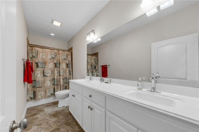 bathroom with vanity, toilet, and walk in shower