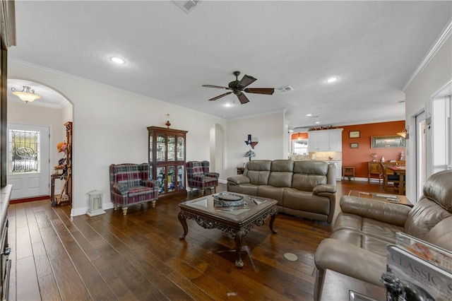 living room with ceiling fan, crown molding, and dark wood-type flooring