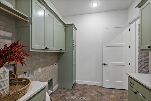 washroom featuring electric dryer hookup and cabinets