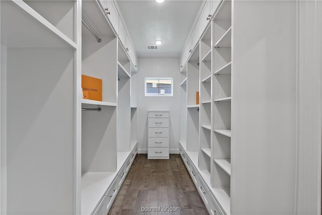 spacious closet with dark hardwood / wood-style floors