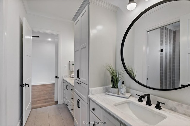 bathroom featuring crown molding, tile patterned flooring, and vanity