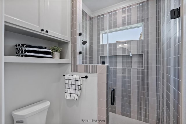 bathroom featuring an enclosed shower and toilet