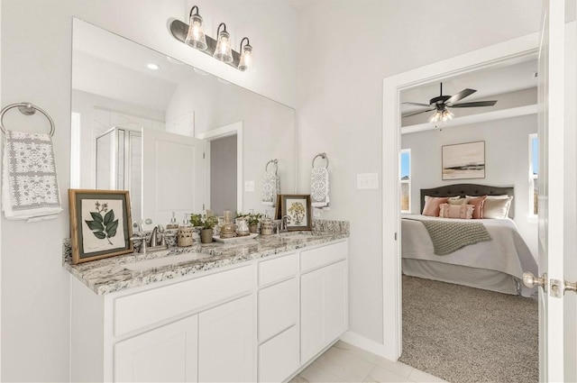 bathroom with ceiling fan, vanity, and a shower with shower door