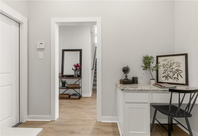 corridor with light hardwood / wood-style floors