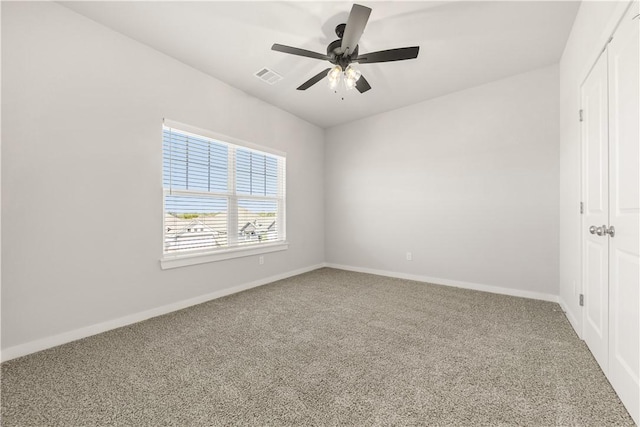 spare room with ceiling fan and carpet floors