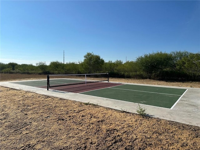 view of home's community featuring tennis court