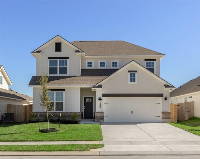 view of front of house with central AC unit, a garage, and a front lawn