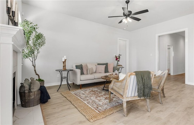 living room with ceiling fan and light hardwood / wood-style floors