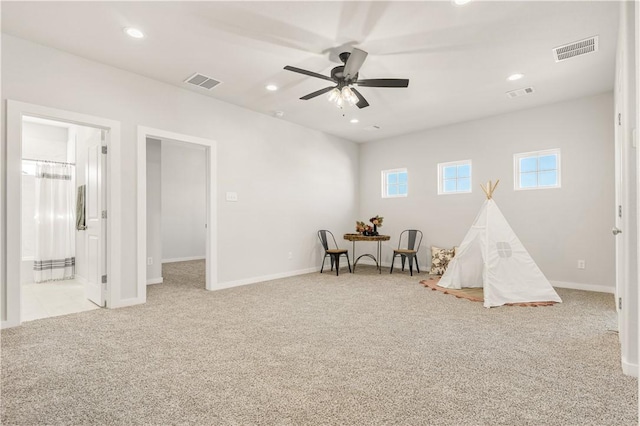 rec room with light colored carpet and ceiling fan