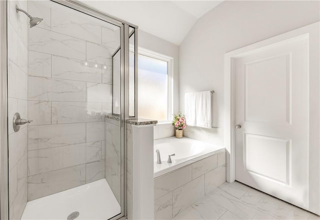 bathroom featuring vaulted ceiling and independent shower and bath