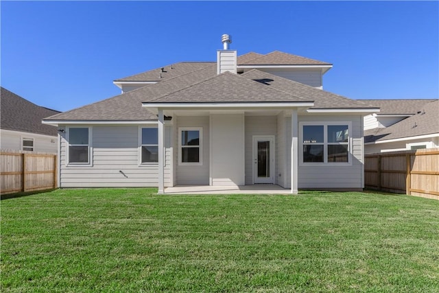 back of property featuring a yard and a patio