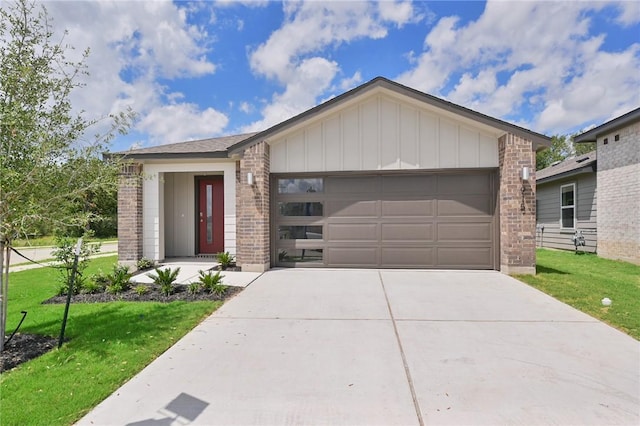 view of front of house featuring concrete driveway, a front lawn, brick siding, and a garage