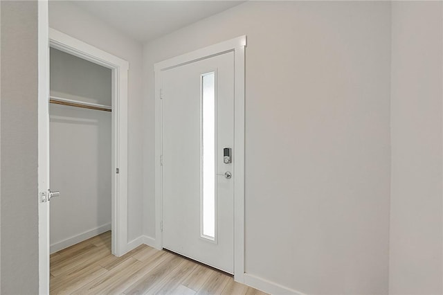 entryway featuring light wood-type flooring and baseboards
