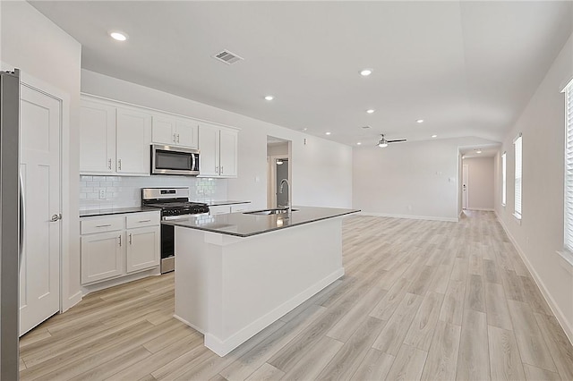 kitchen with light wood-type flooring, visible vents, appliances with stainless steel finishes, and a sink