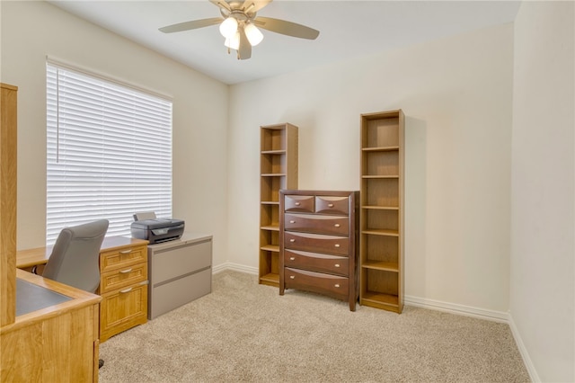 office featuring light colored carpet, a wealth of natural light, and ceiling fan