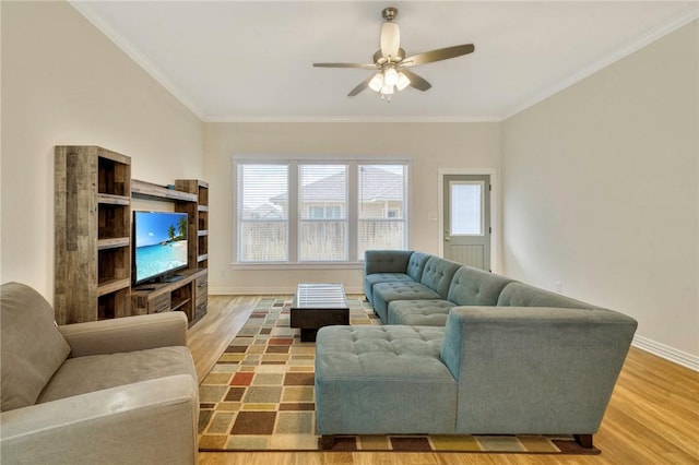 living room featuring hardwood / wood-style floors, ornamental molding, and a wealth of natural light