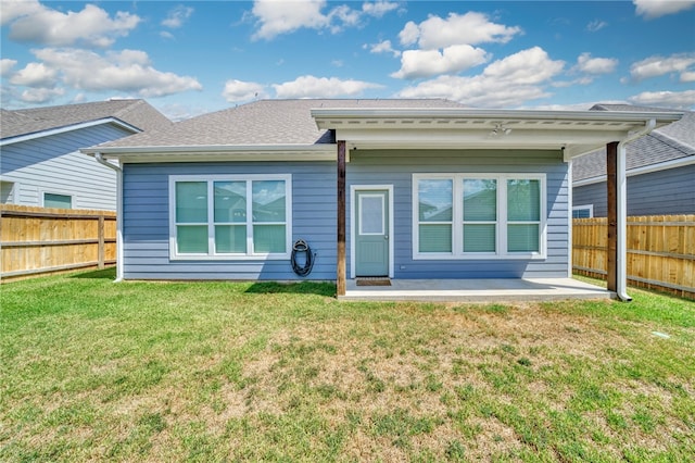 rear view of house featuring a patio area and a lawn