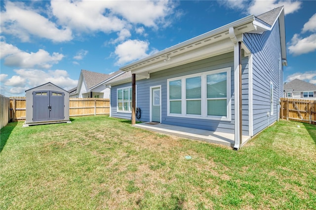 rear view of house featuring a lawn and a storage unit