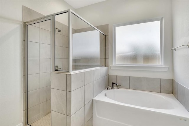 bathroom with shower with separate bathtub