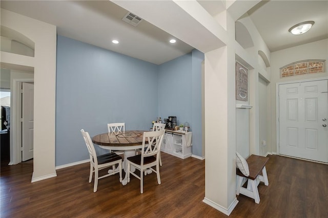 dining area featuring visible vents, baseboards, and wood finished floors