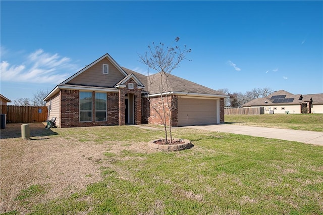 view of front facade with brick siding, fence, concrete driveway, a front yard, and a garage