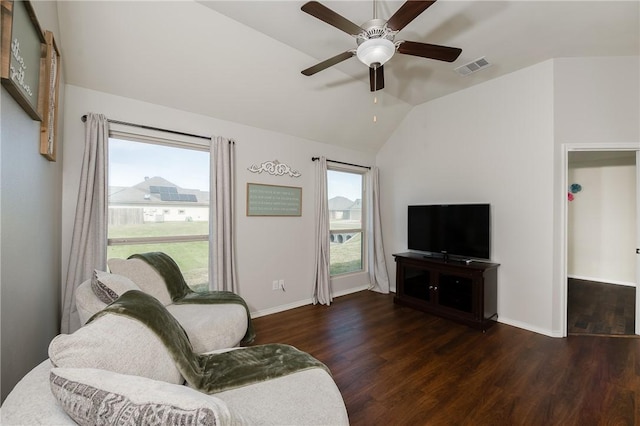 living area with visible vents, wood finished floors, baseboards, lofted ceiling, and ceiling fan