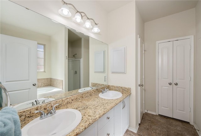 full bathroom with a sink, a garden tub, and a shower stall