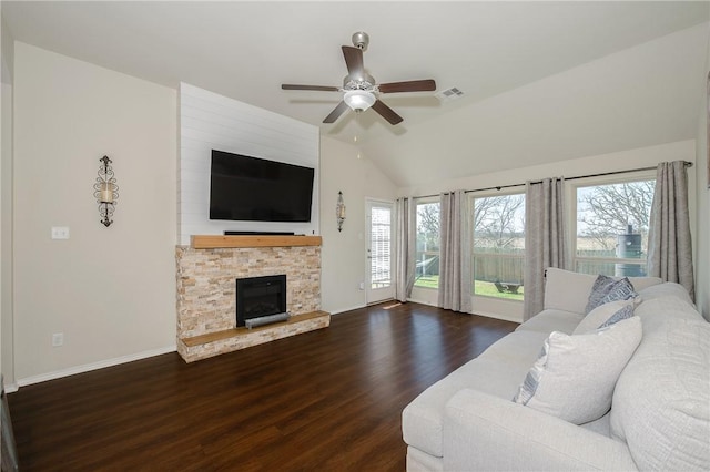 living area featuring visible vents, ceiling fan, vaulted ceiling, a fireplace, and wood finished floors