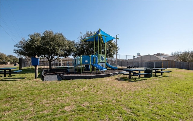 communal playground with a lawn and fence