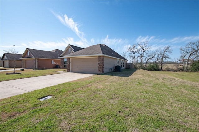 view of side of property featuring central air condition unit, driveway, a yard, a garage, and brick siding