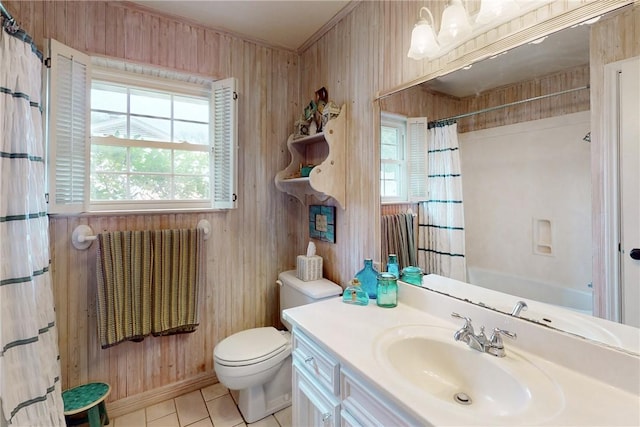 bathroom with toilet, wooden walls, vanity, and tile patterned floors