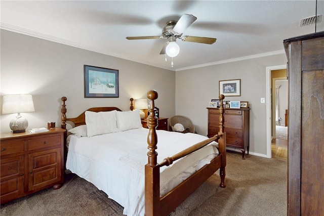 carpeted bedroom featuring ceiling fan, ornamental molding, visible vents, and baseboards