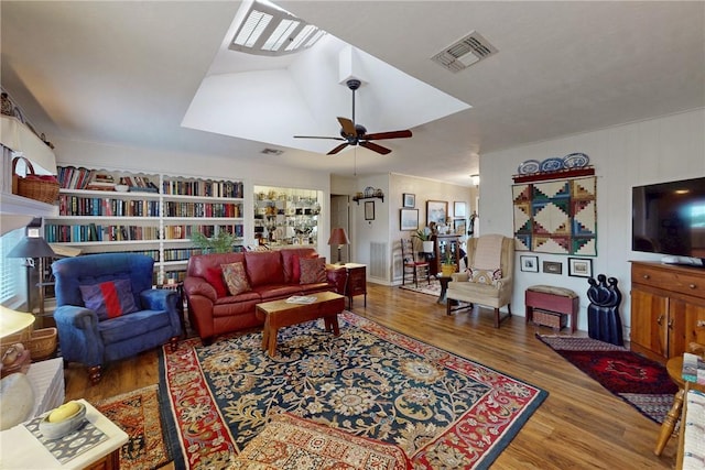 living room featuring ceiling fan, visible vents, and wood finished floors