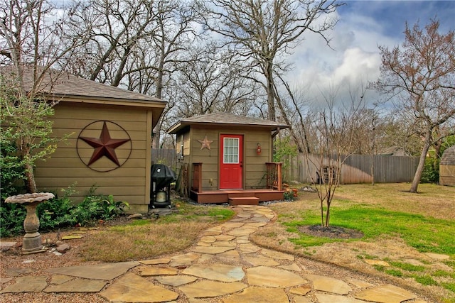 view of outbuilding featuring an outbuilding and fence