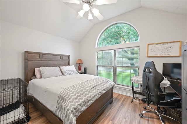 bedroom featuring lofted ceiling, wood finished floors, a ceiling fan, and a desk
