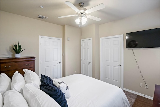 bedroom with ceiling fan and dark wood-type flooring