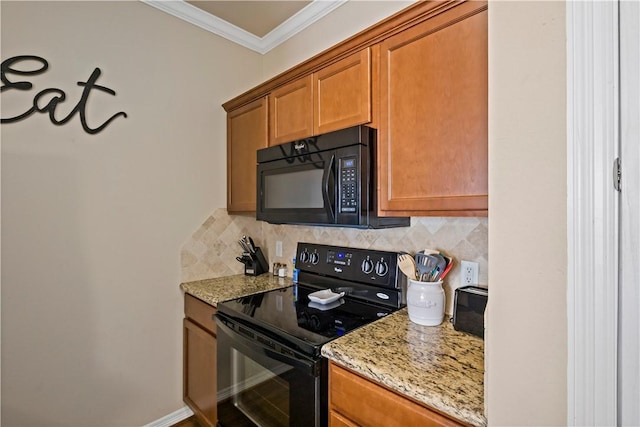 kitchen with light stone countertops, backsplash, ornamental molding, and black appliances