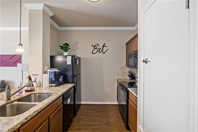 kitchen featuring pendant lighting, dark wood-type flooring, black appliances, sink, and ornamental molding