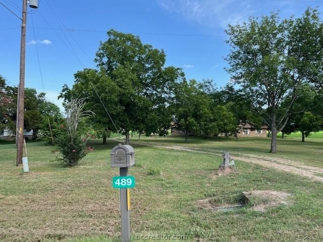 view of property's community with a lawn