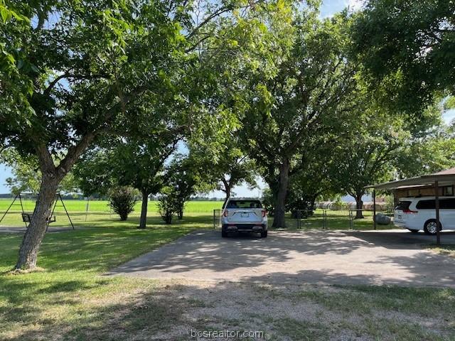 exterior space featuring a yard and a carport