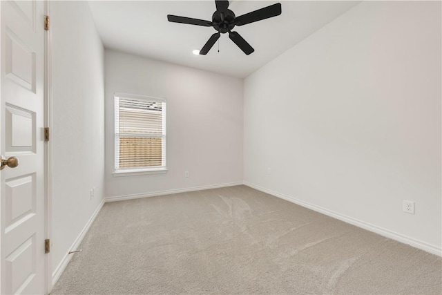 spare room featuring light colored carpet and ceiling fan