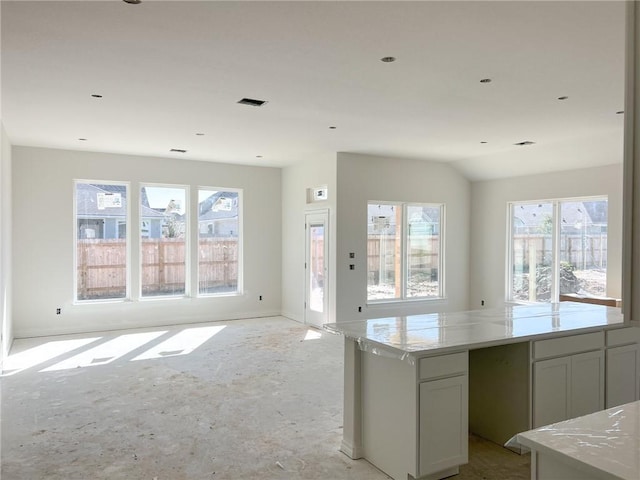 kitchen featuring a kitchen island and light stone countertops