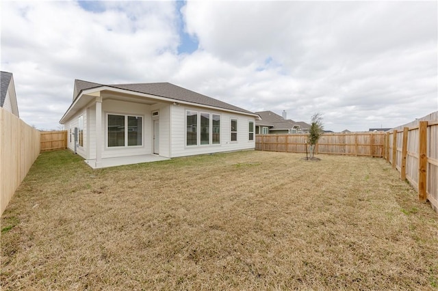 back of house with a yard