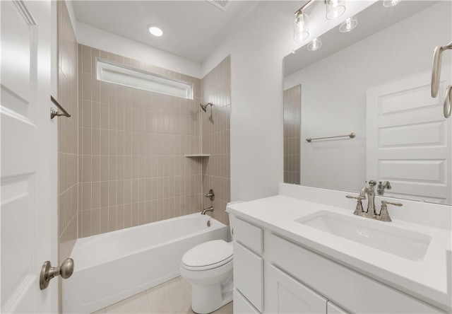 full bathroom featuring tiled shower / bath, vanity, tile patterned floors, and toilet